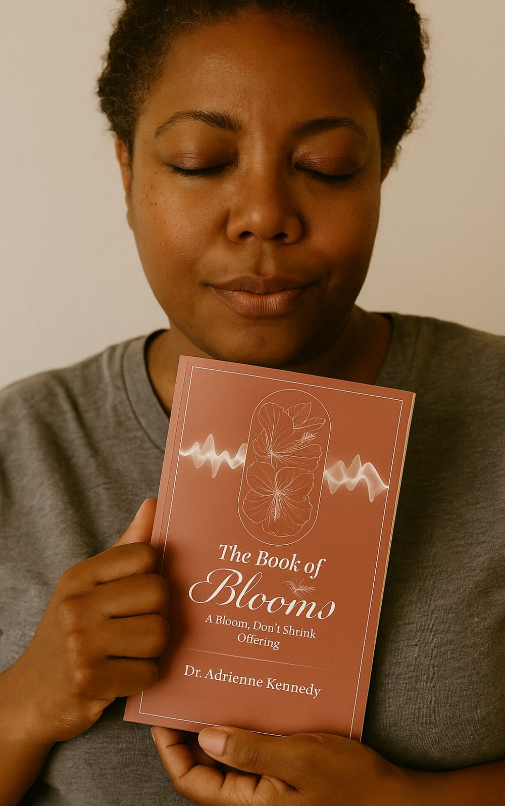 Dr. Adrienne Kennedy holding The Book of Blooms